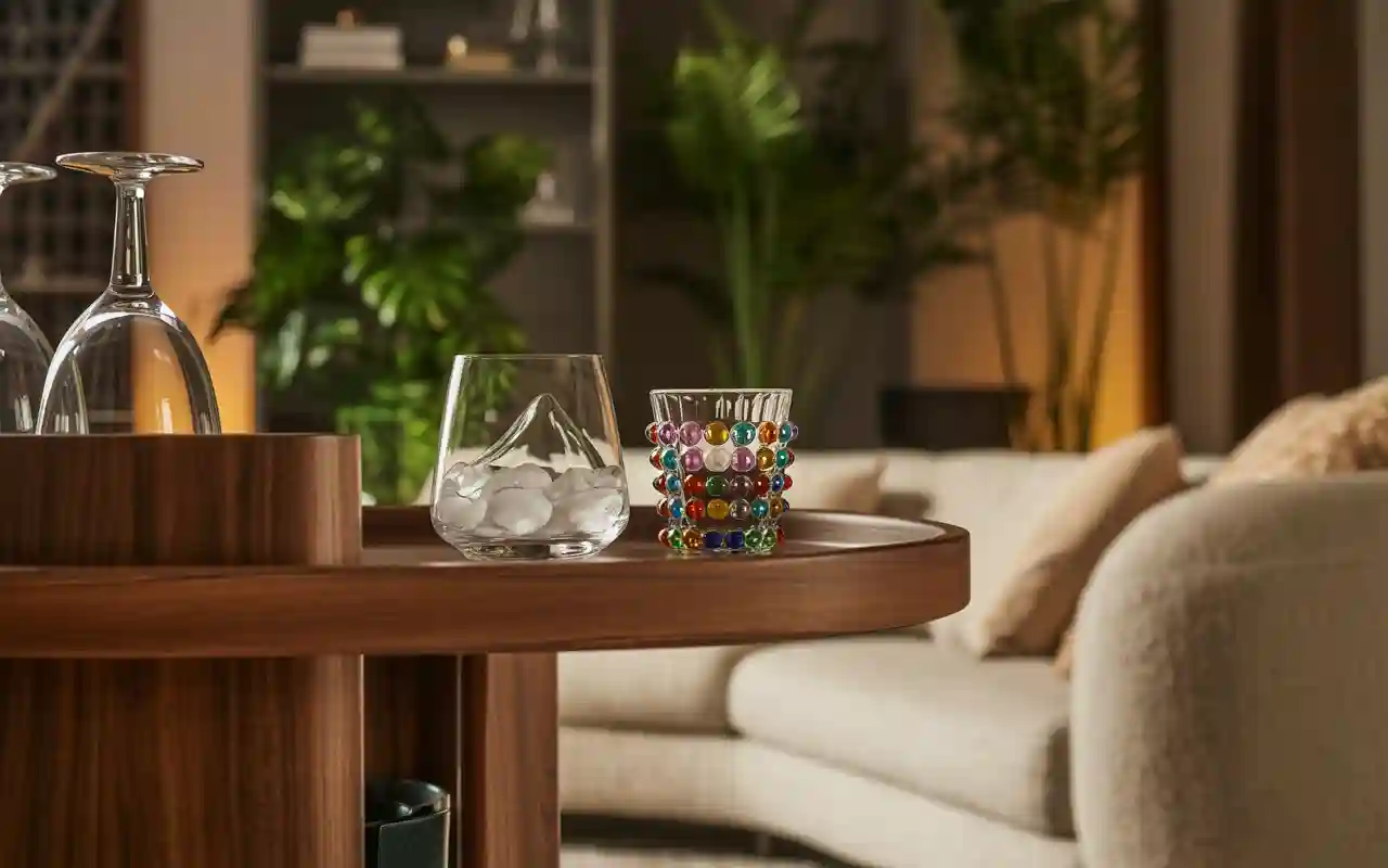 A collection of aesthetic and unique glassware for a home bar, including vintage-style glasses and modern coffee mugs.